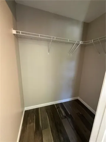 a view of a room with wooden floor and white walls
