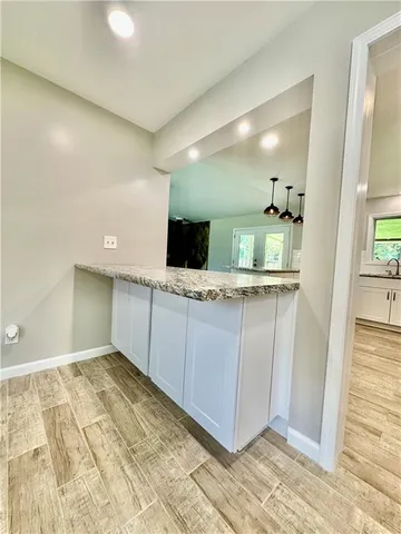 a view of a kitchen cabinets and a wooden floor