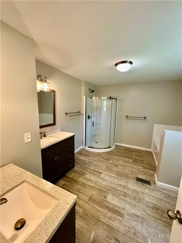 a bathroom with a granite countertop sink and a mirror