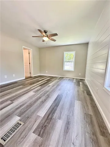 wooden floor in an empty room with a window