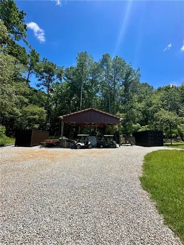 a backyard of a house with a yard and outdoor seating