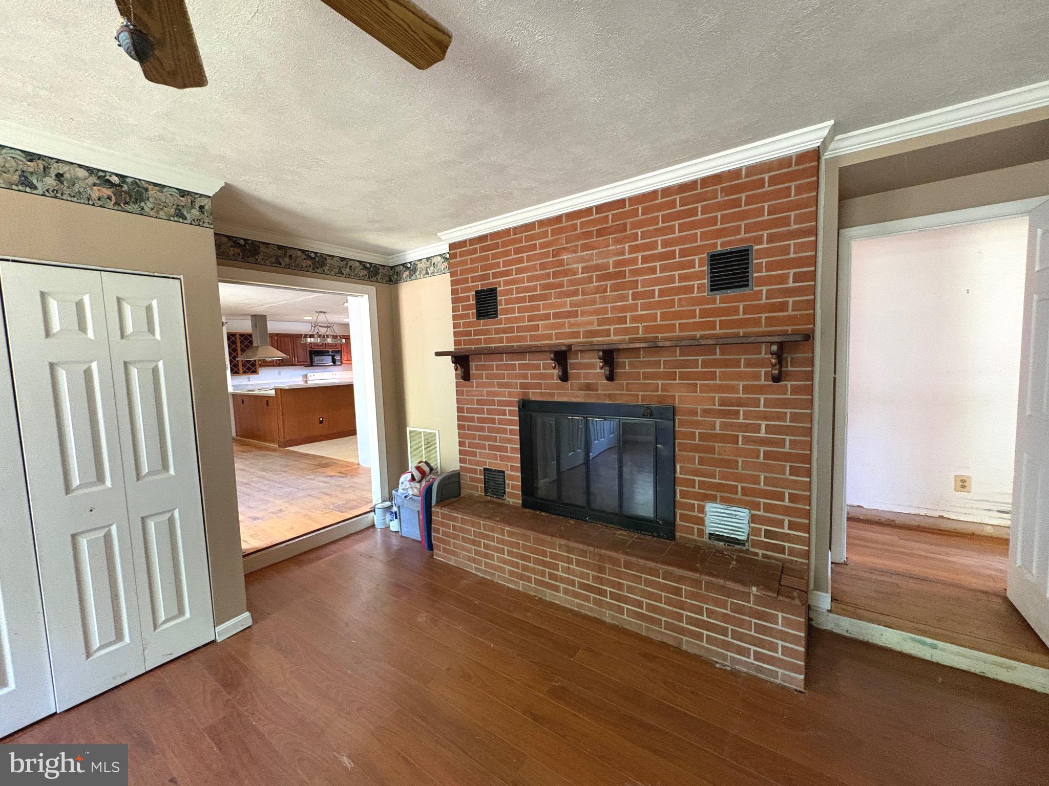 4215 Buffalo Road Mount Airy, MD 21771 - Photo 3 of 44 a view of a livingroom with wooden floor and a fireplace