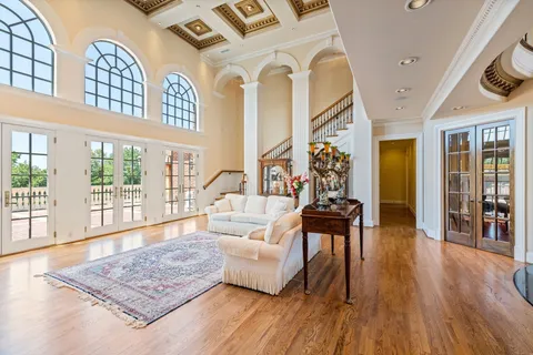a living room with fireplace furniture and a book shelf
