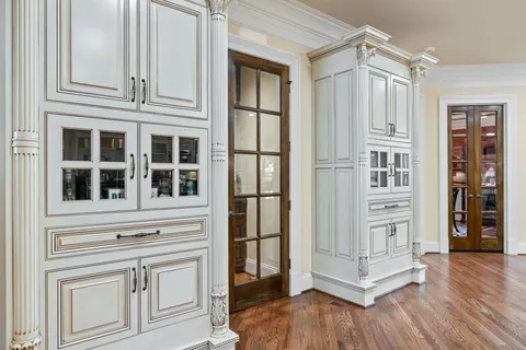 a bedroom with a bed and a flat tv screen on dresser