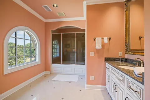 a bedroom with bed and a refrigerator