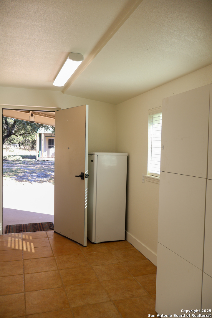 1031 Shin Oak Road Menard, TX 76859 - Photo 11 of 31 a view of an empty room with wooden floor and a window