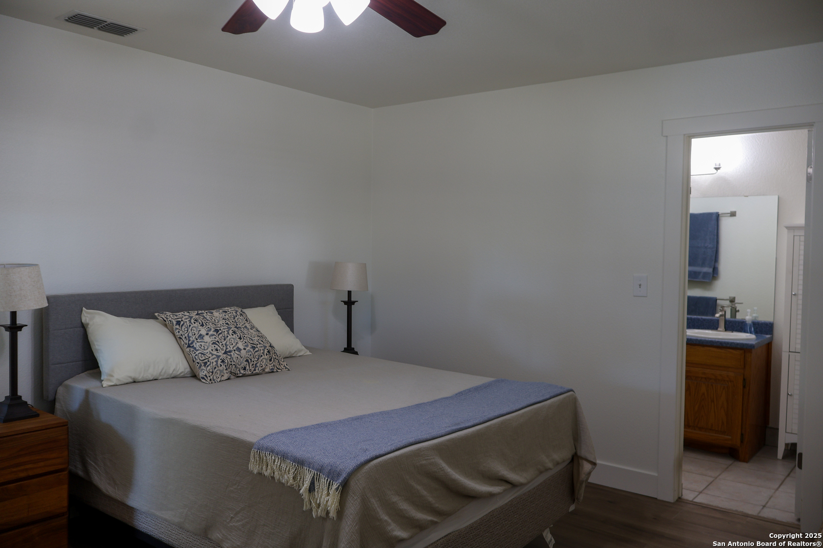 1031 Shin Oak Road Menard, TX 76859 - Photo 18 of 31 a bedroom with a bed and wooden floor