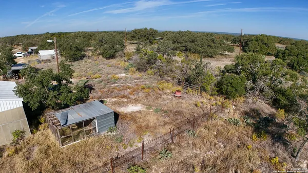 an aerial view of house with yard and mountain in back