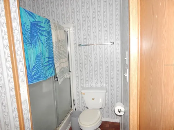 a white toilet sitting next to a shower curtain