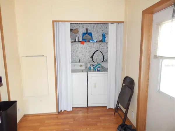 a view of a hallway with workspace and a window