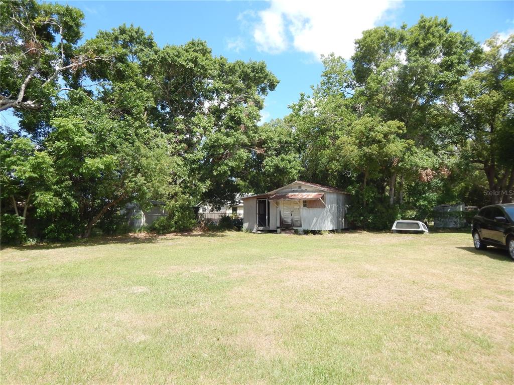 900 Columbia Avenue St. Cloud, FL 34769 - Photo 19 of 19 a house with trees in the background