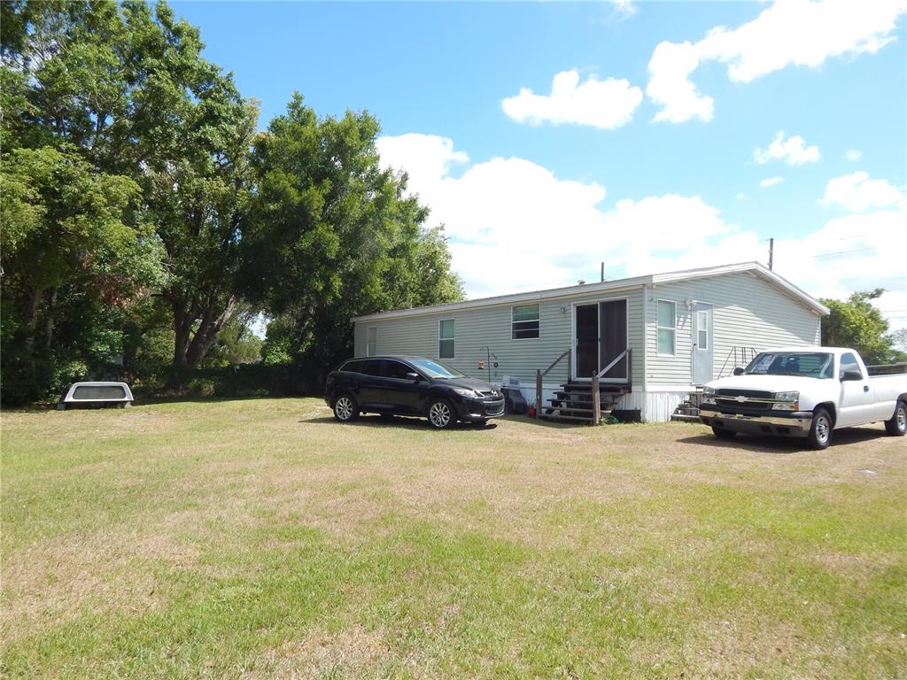900 Columbia Avenue St. Cloud, FL 34769 - Photo 2 of 19 a view of a house with backyard space and deck