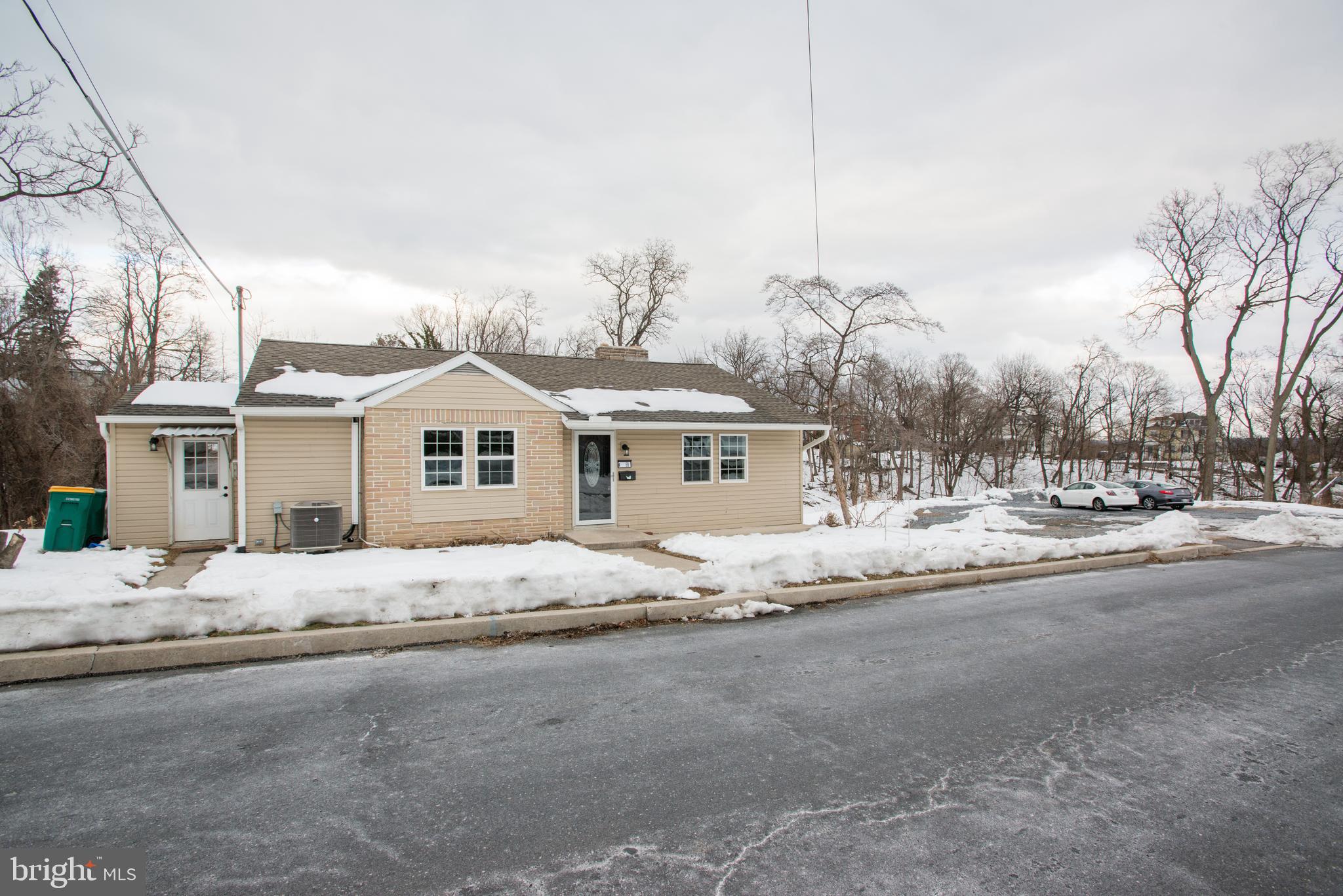 99 East Perry Street Enola, PA 17025 - Photo 1 of 18 a white house with a large tree in front of it