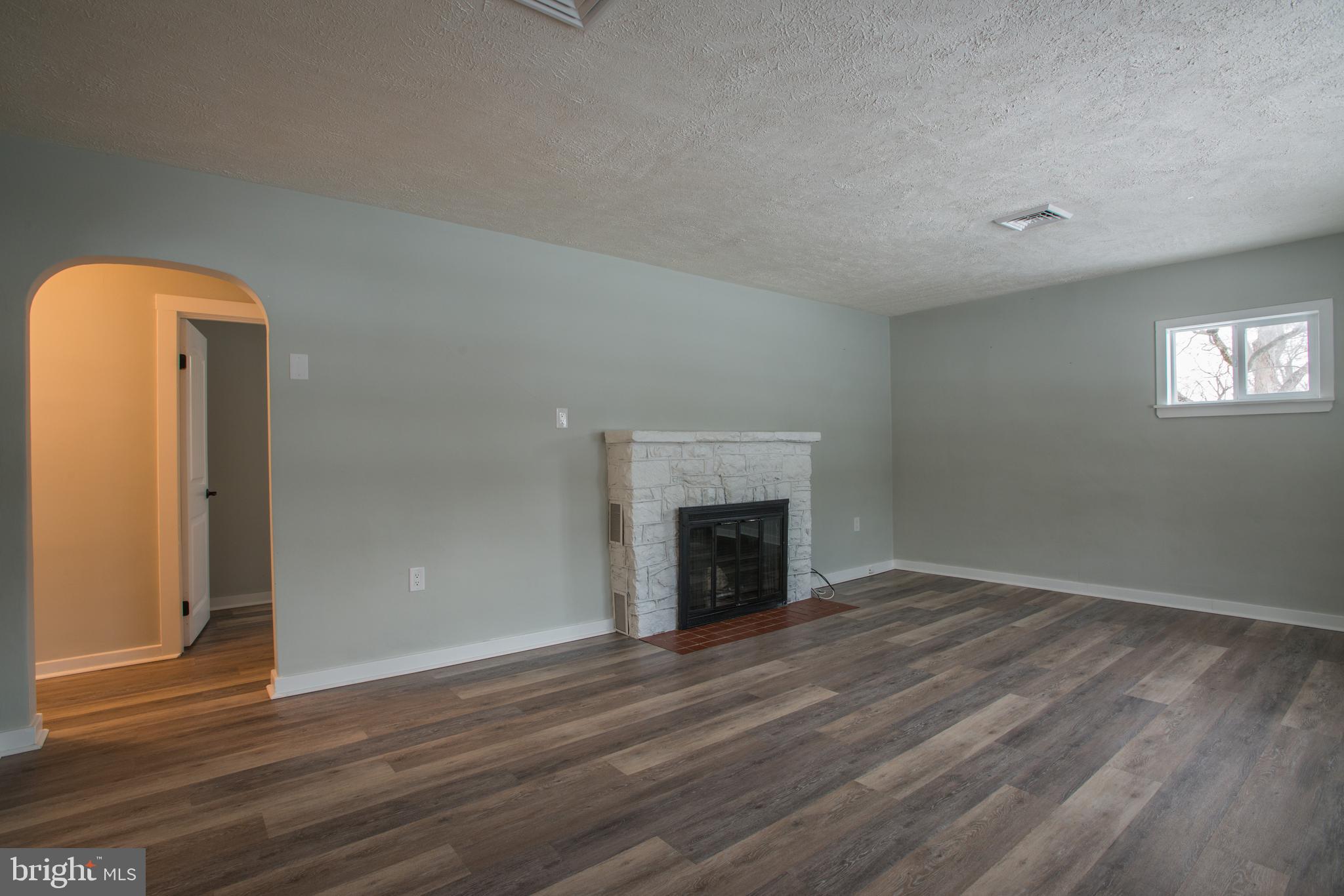 99 East Perry Street Enola, PA 17025 - Photo 2 of 18 a view of empty room with wooden floor and fireplace