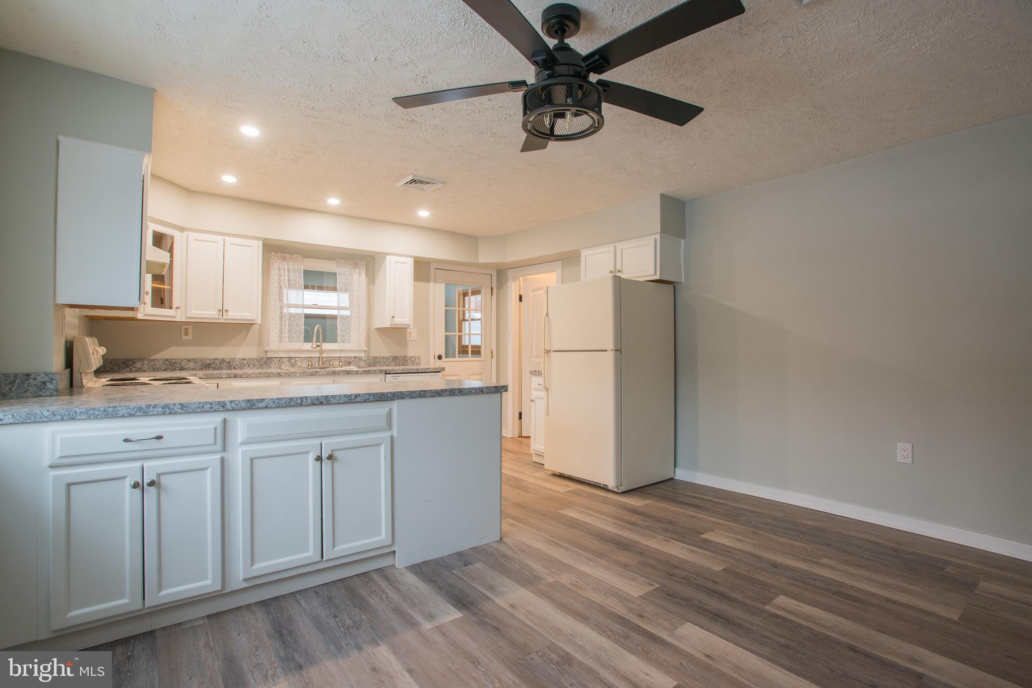 99 East Perry Street Enola, PA 17025 - Photo 5 of 18 a kitchen with granite countertop a refrigerator and a sink