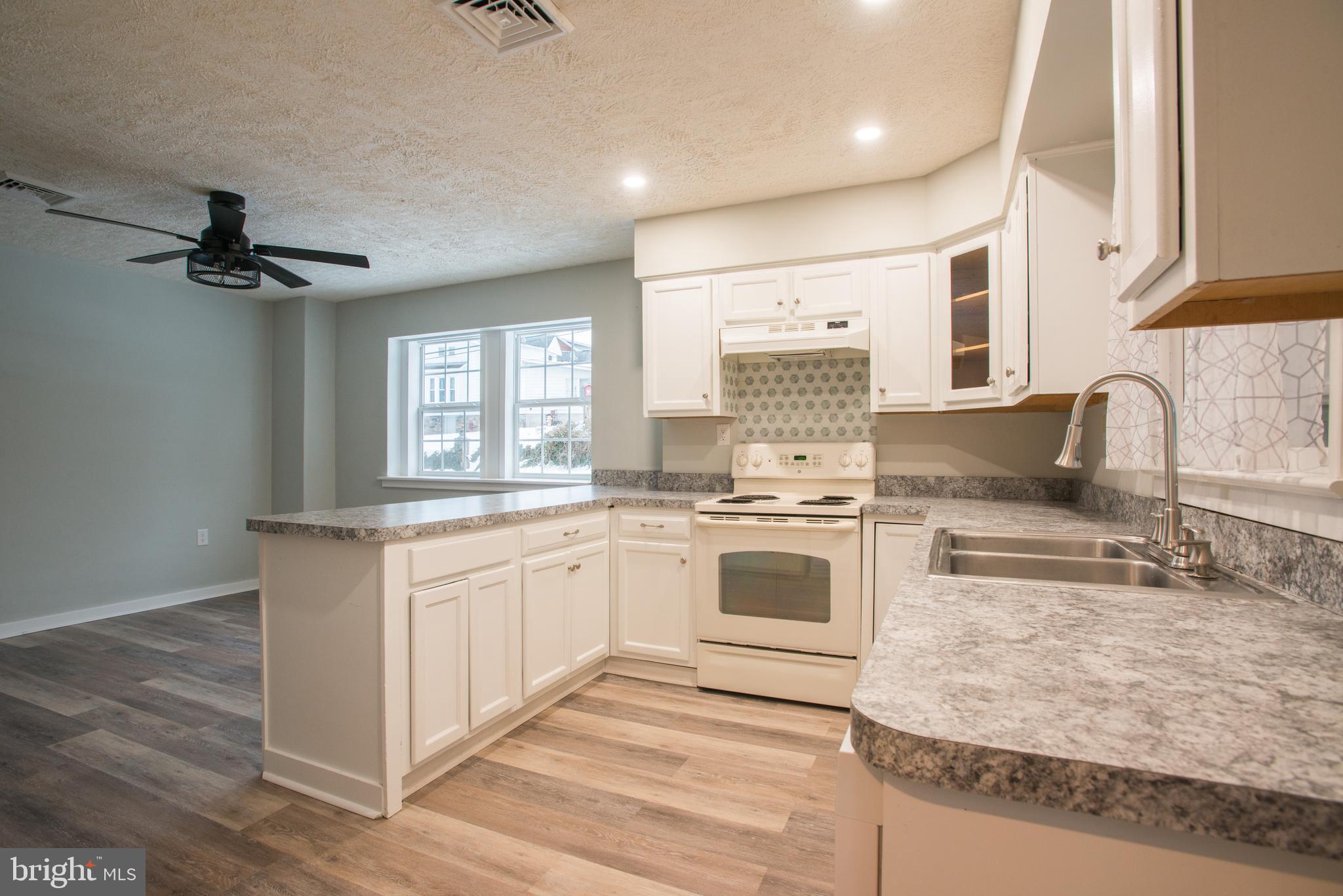 99 East Perry Street Enola, PA 17025 - Photo 6 of 18 a kitchen with granite countertop a sink stainless steel appliances and cabinets