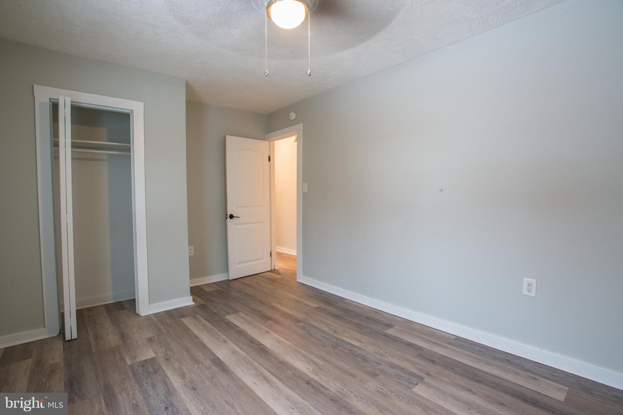 99 East Perry Street Enola, PA 17025 - Photo 8 of 18 a view of an empty room with wooden floor