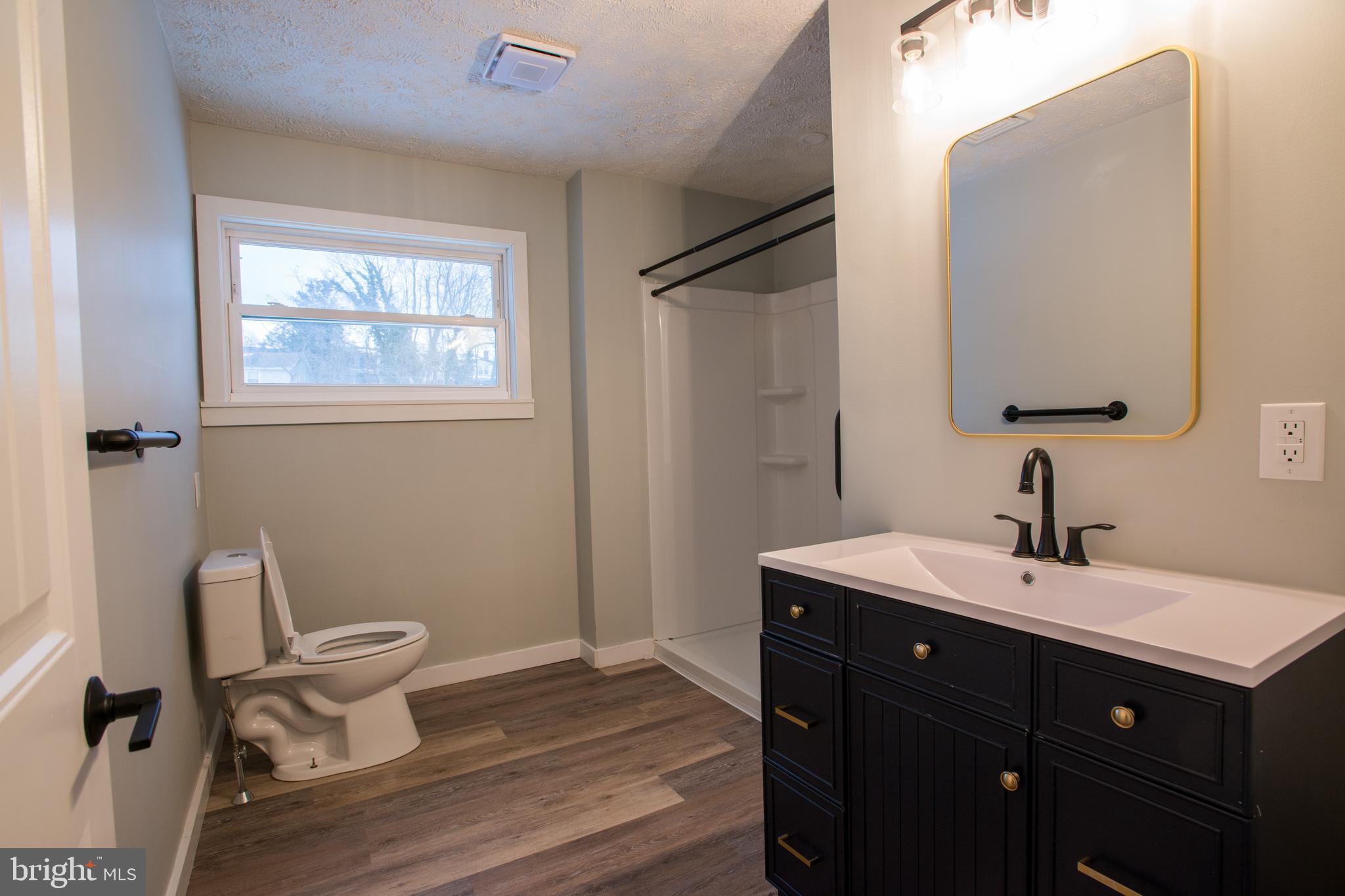 99 East Perry Street Enola, PA 17025 - Photo 9 of 18 a bathroom with a sink mirror vanity and a toilet