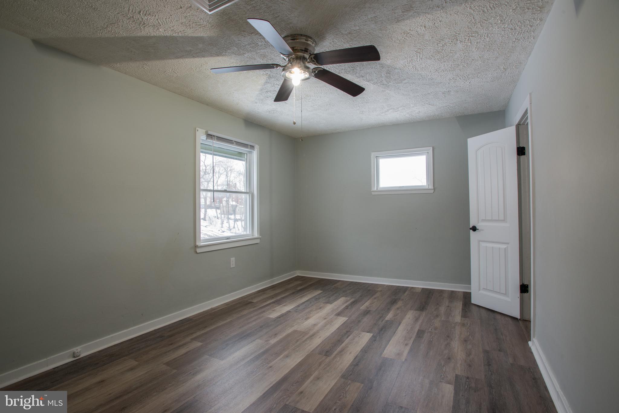99 East Perry Street Enola, PA 17025 - Photo 10 of 18 wooden floor in an empty room with a window