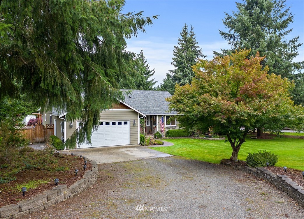 18811 Nutmeg Street Southwest Rochester, WA 98579 - Photo 1 of 25 a view of a house with yard and large trees