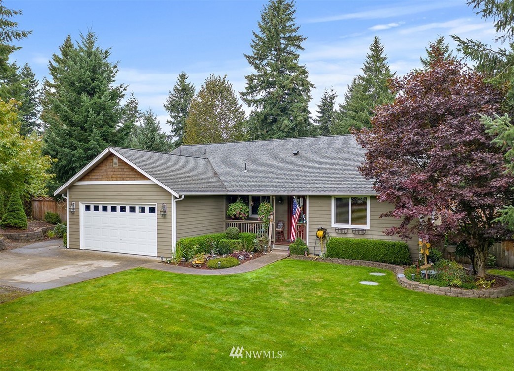 18811 Nutmeg Street Southwest Rochester, WA 98579 - Photo 2 of 25 a front view of a house with a garden and plants