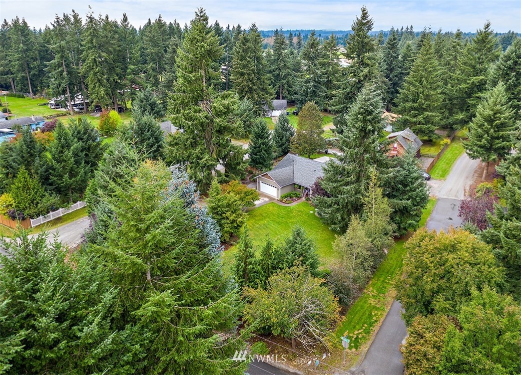 18811 Nutmeg Street Southwest Rochester, WA 98579 - Photo 13 of 25 a view of a house with a lush green forest