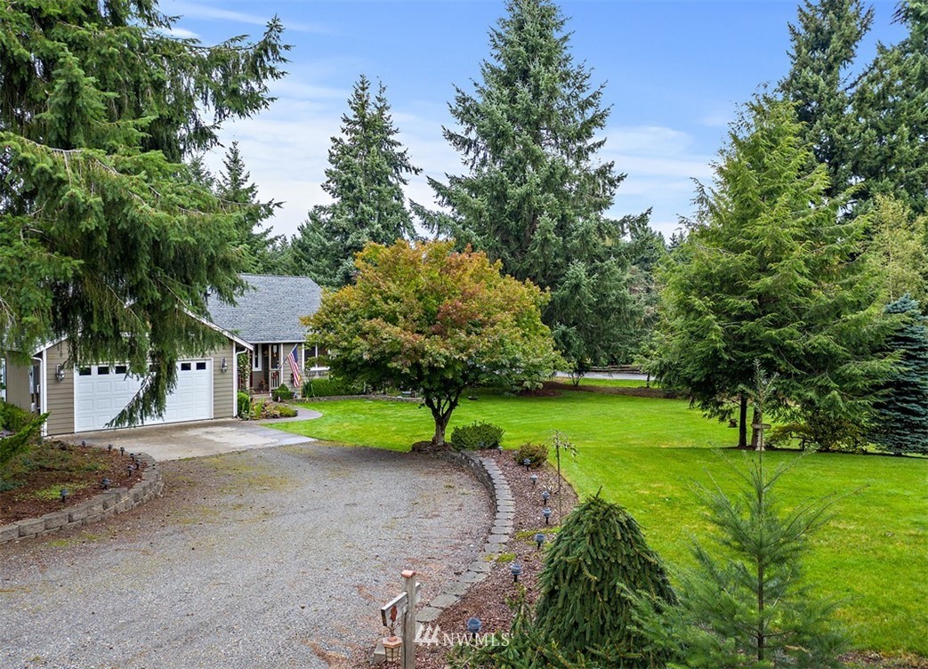 18811 Nutmeg Street Southwest Rochester, WA 98579 - Photo 17 of 25 a yellow house with trees in front of it