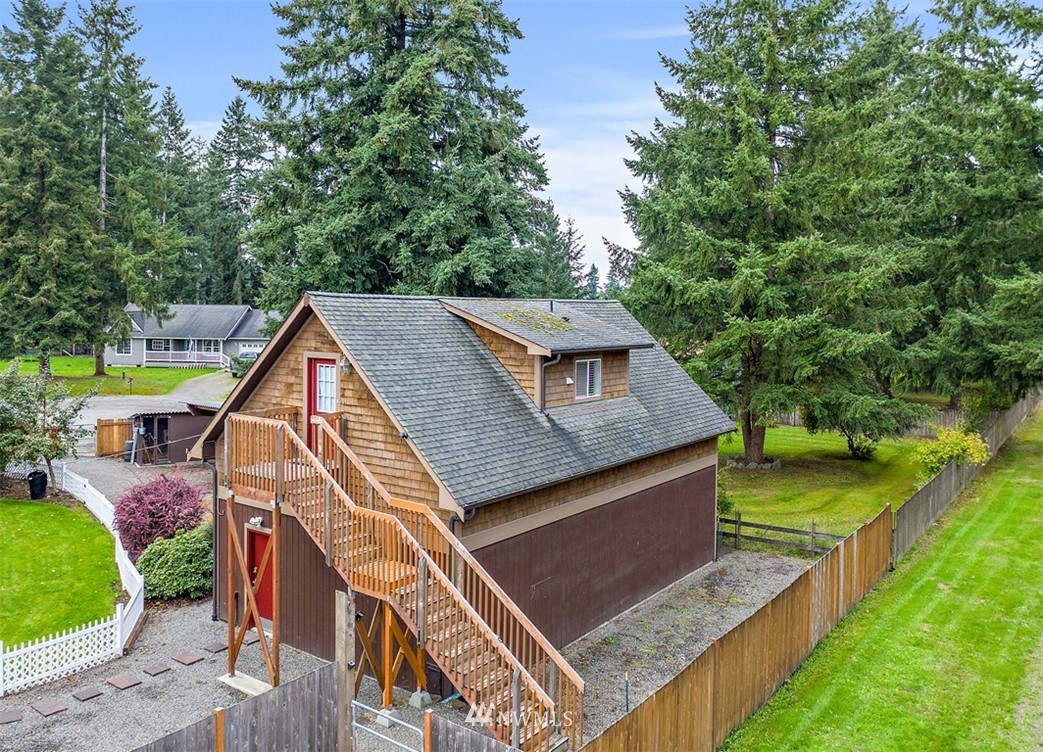 18811 Nutmeg Street Southwest Rochester, WA 98579 - Photo 4 of 25 an aerial view of a house with swimming pool and trees
