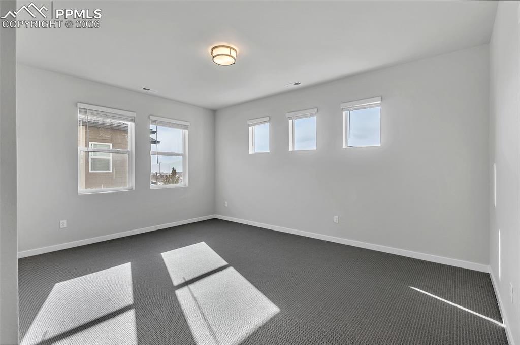 13633 Flurry Heights Colorado Springs, CO 80921 - Photo 13 of 31 an empty room with windows