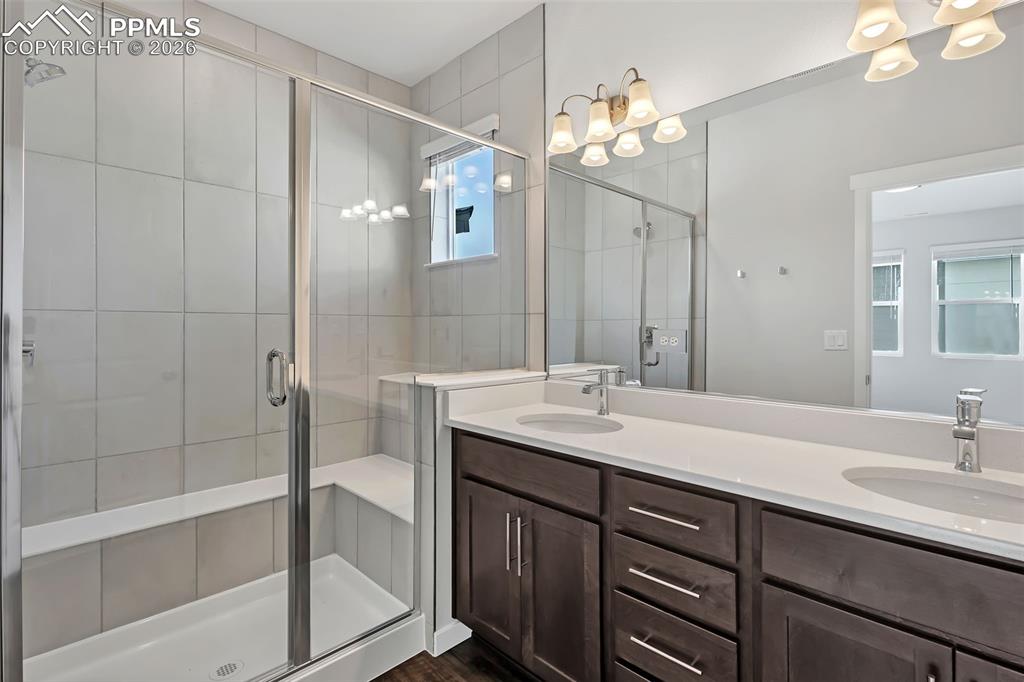 13633 Flurry Heights Colorado Springs, CO 80921 - Photo 15 of 31 a bathroom with a double vanity sink mirror and shower