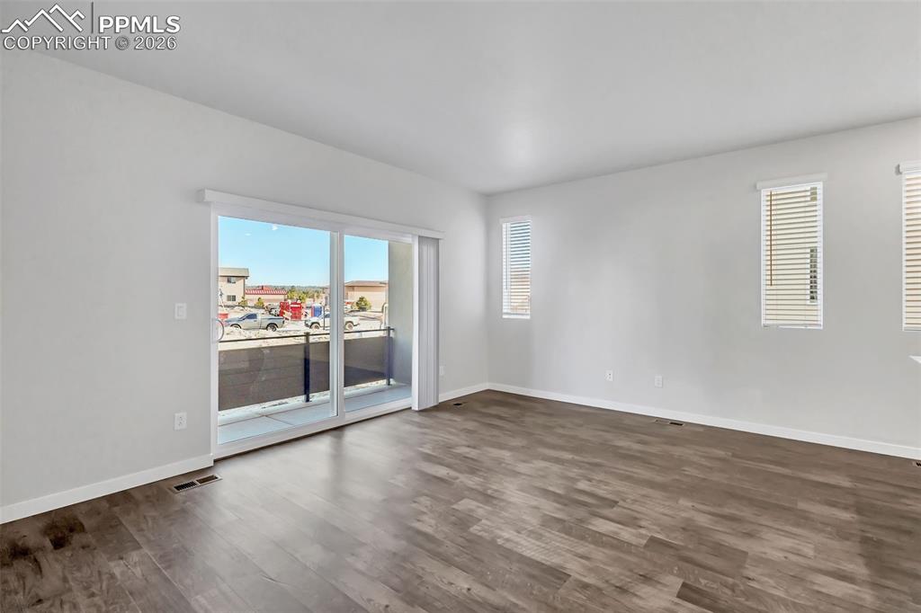 13633 Flurry Heights Colorado Springs, CO 80921 - Photo 18 of 31 a view of a room with wooden floor and window