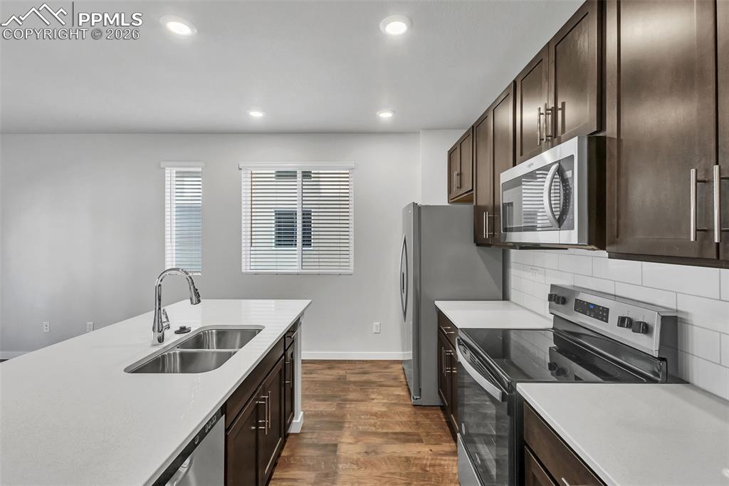 13633 Flurry Heights Colorado Springs, CO 80921 - Photo 23 of 31 a kitchen with stainless steel appliances granite countertop a sink stove and refrigerator