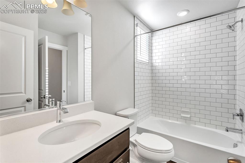 13633 Flurry Heights Colorado Springs, CO 80921 - Photo 28 of 31 a bathroom with a sink a toilet and shower