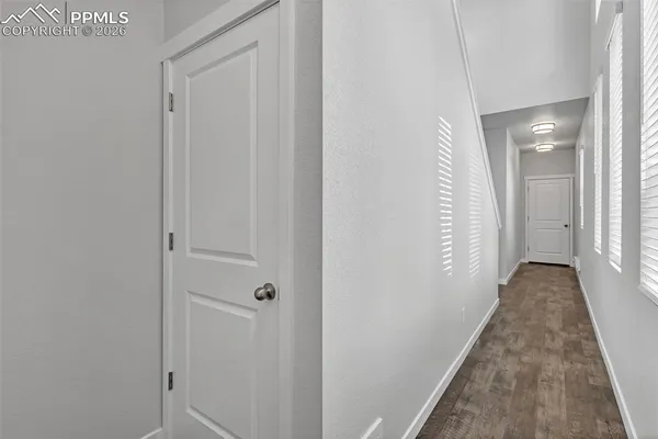 a view of a hallway with wooden floor