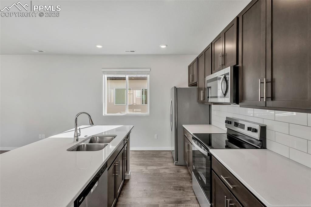 13633 Flurry Heights Colorado Springs, CO 80921 - Photo 6 of 31 a kitchen with stainless steel appliances granite countertop a sink stove and refrigerator