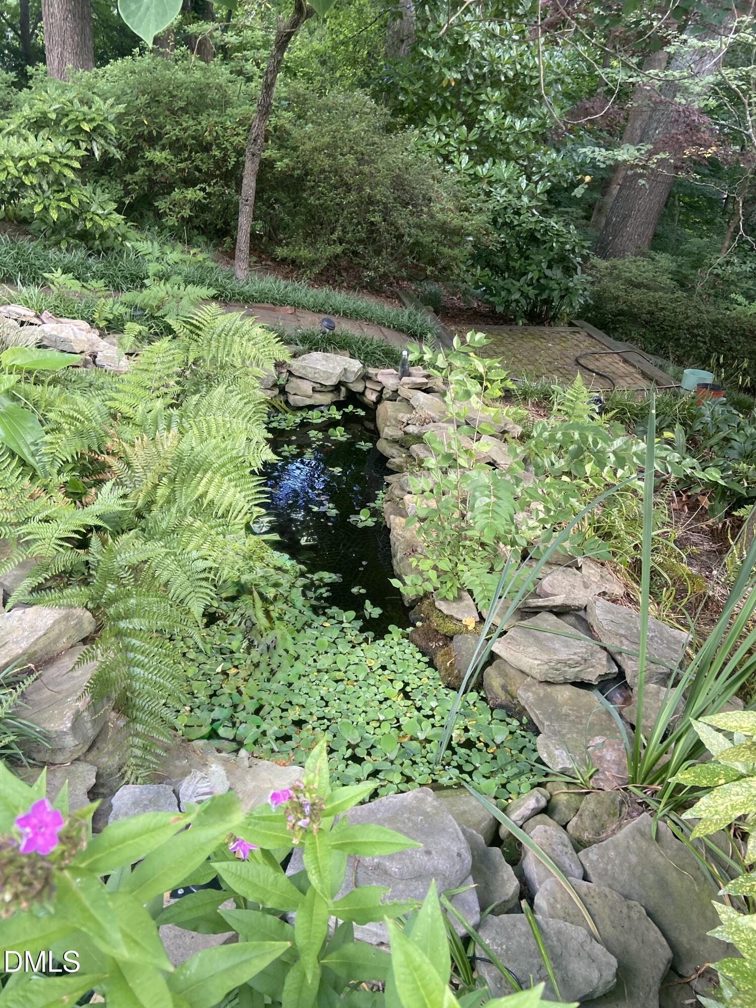 1100 Sudbury Court Raleigh, NC 27609 - Photo 18 of 56 a backyard of a house with a yard and outdoor seating
