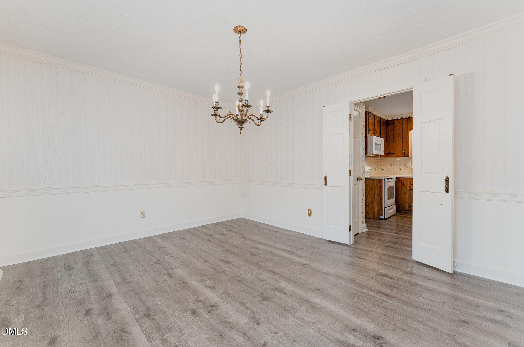 1100 Sudbury Court Raleigh, NC 27609 - Photo 29 of 56 a view of an empty room with wooden floor and a window
