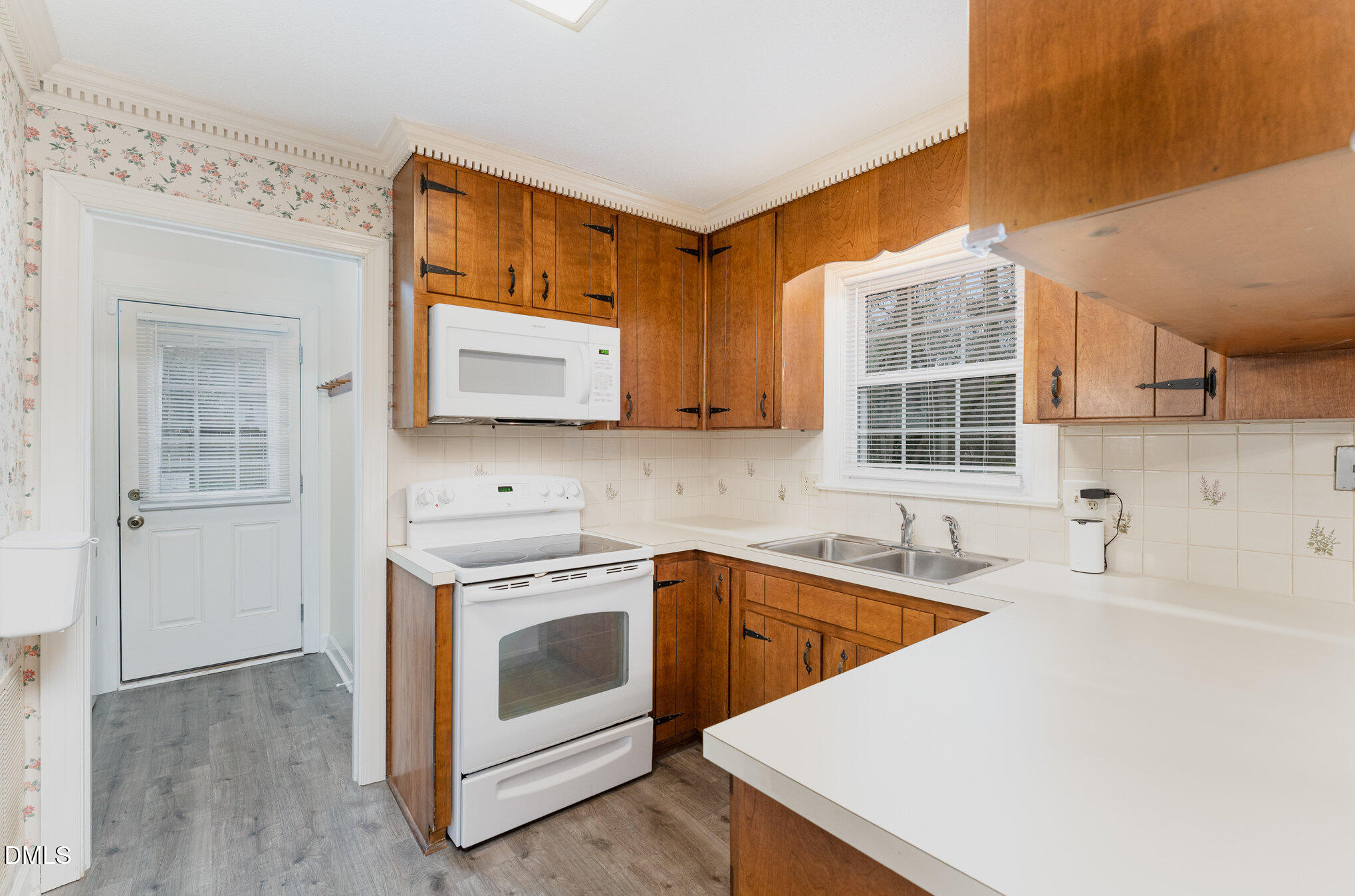1100 Sudbury Court Raleigh, NC 27609 - Photo 30 of 56 a kitchen with stainless steel appliances a stove a sink and a microwave