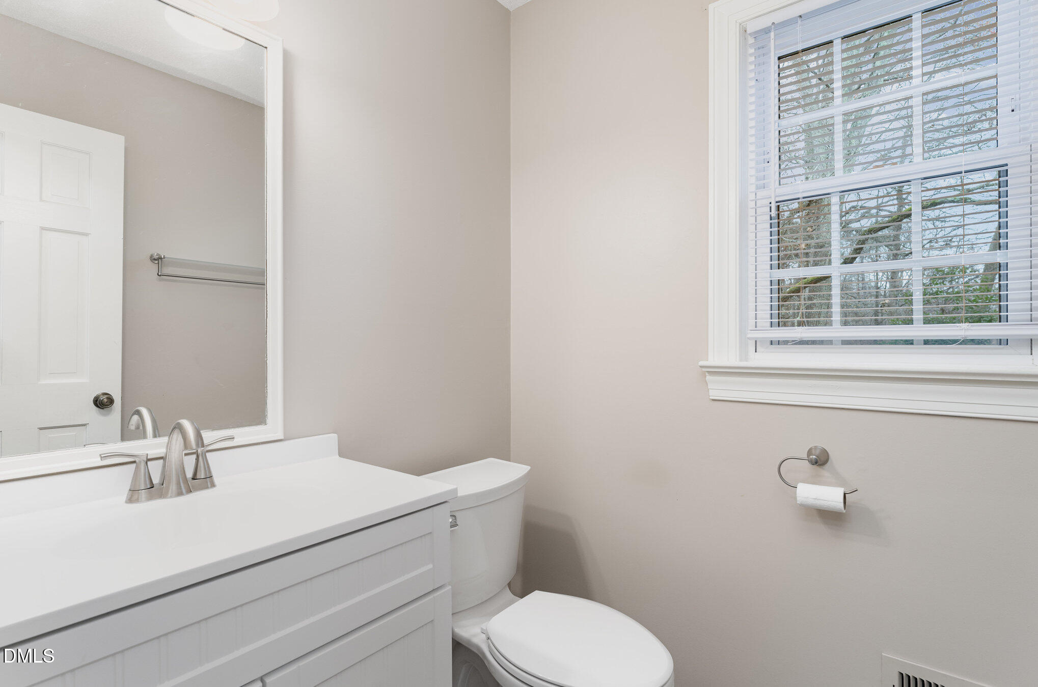 1100 Sudbury Court Raleigh, NC 27609 - Photo 37 of 56 a bathroom with a sink a toilet and a mirror