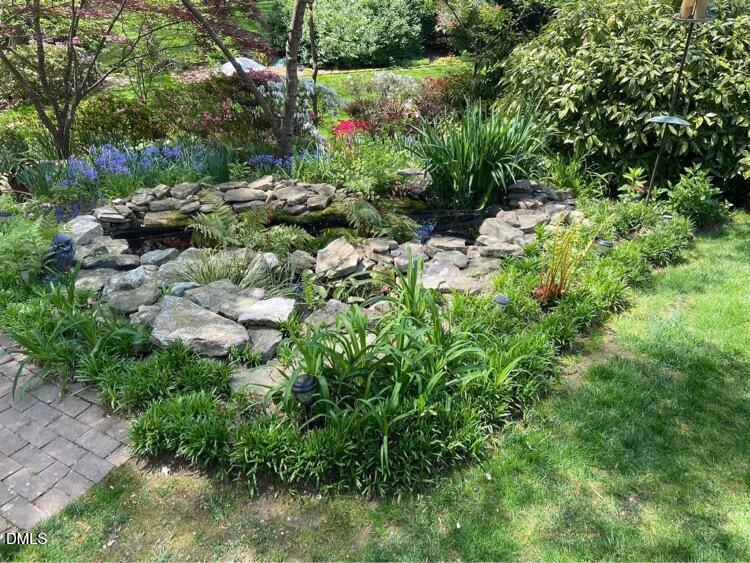 1100 Sudbury Court Raleigh, NC 27609 - Photo 7 of 56 a view of a garden with a tree