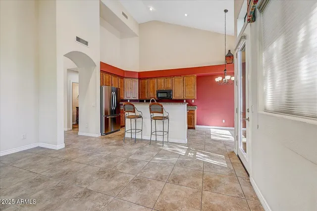 a view of a kitchen with chairs and window