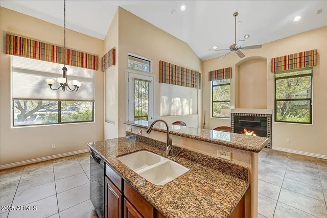 a kitchen with granite countertop a sink and a window