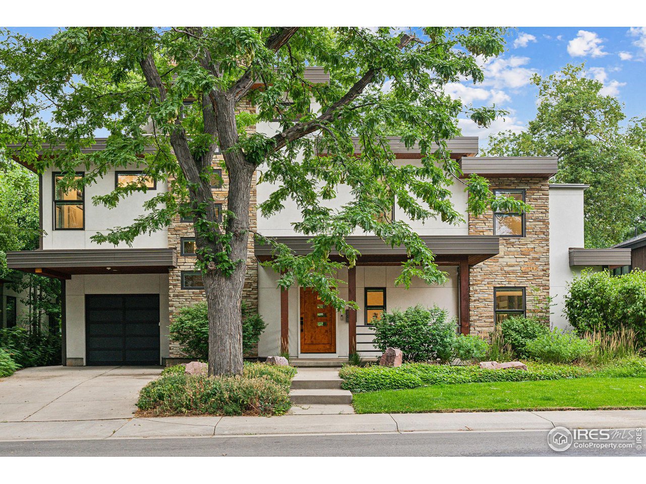 Undisclosed Address Boulder, CO 80304 - Photo 1 of 1 a front view of a house with a yard and trees