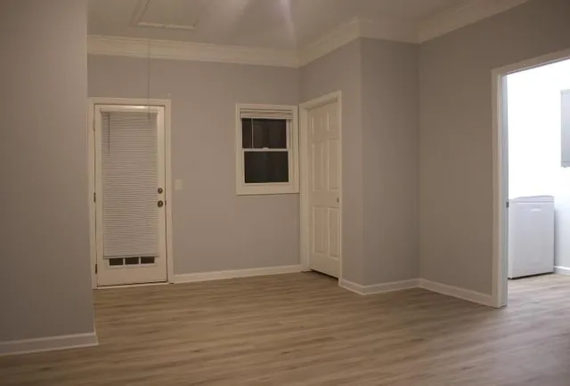 an empty room with wooden floor and closet
