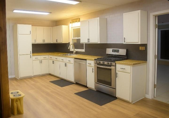 1757 Litchfield Road Southwest Snellville, GA 30078 - Photo 3 of 17 a kitchen with a stove sink and cabinets