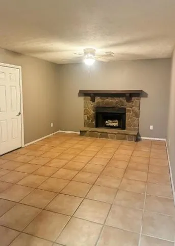 a view of an empty room with a fireplace