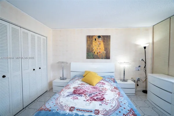a bedroom with a bed and a view of bathroom