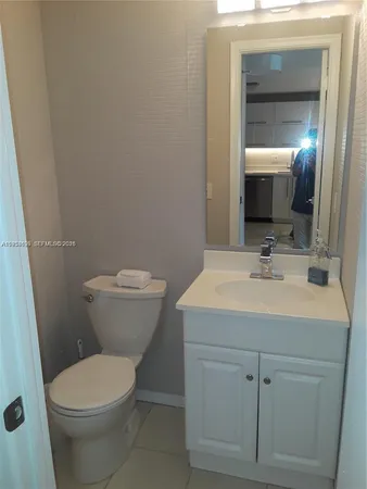 a bathroom with a sink toilet and mirror