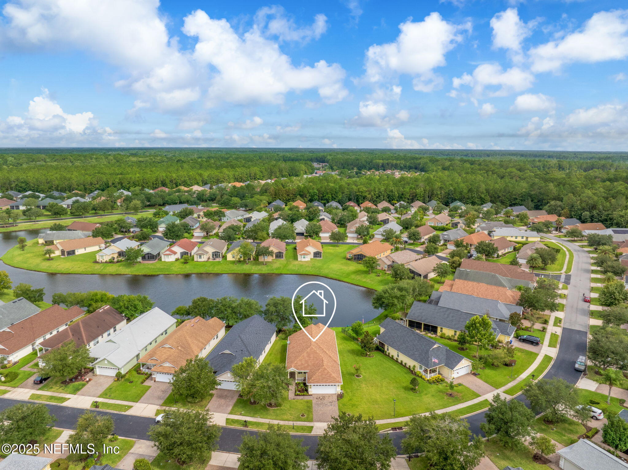 an aerial view of residential houses with outdoor space and ocean view