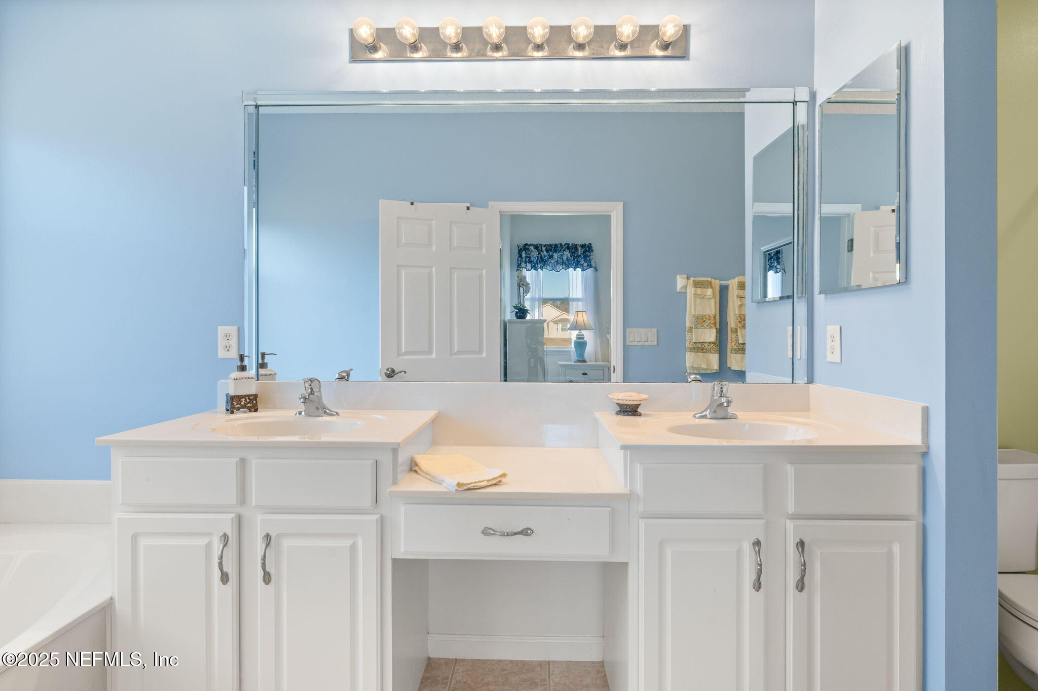 697 Copperhead Circle St. Augustine, FL 32092 - Photo 15 of 26 a bathroom with a sink vanity and a mirror